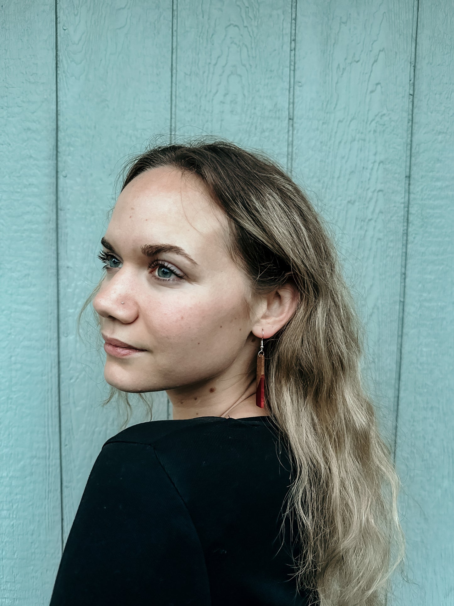 Beautiful girl wearing handmade wooden stem earrings